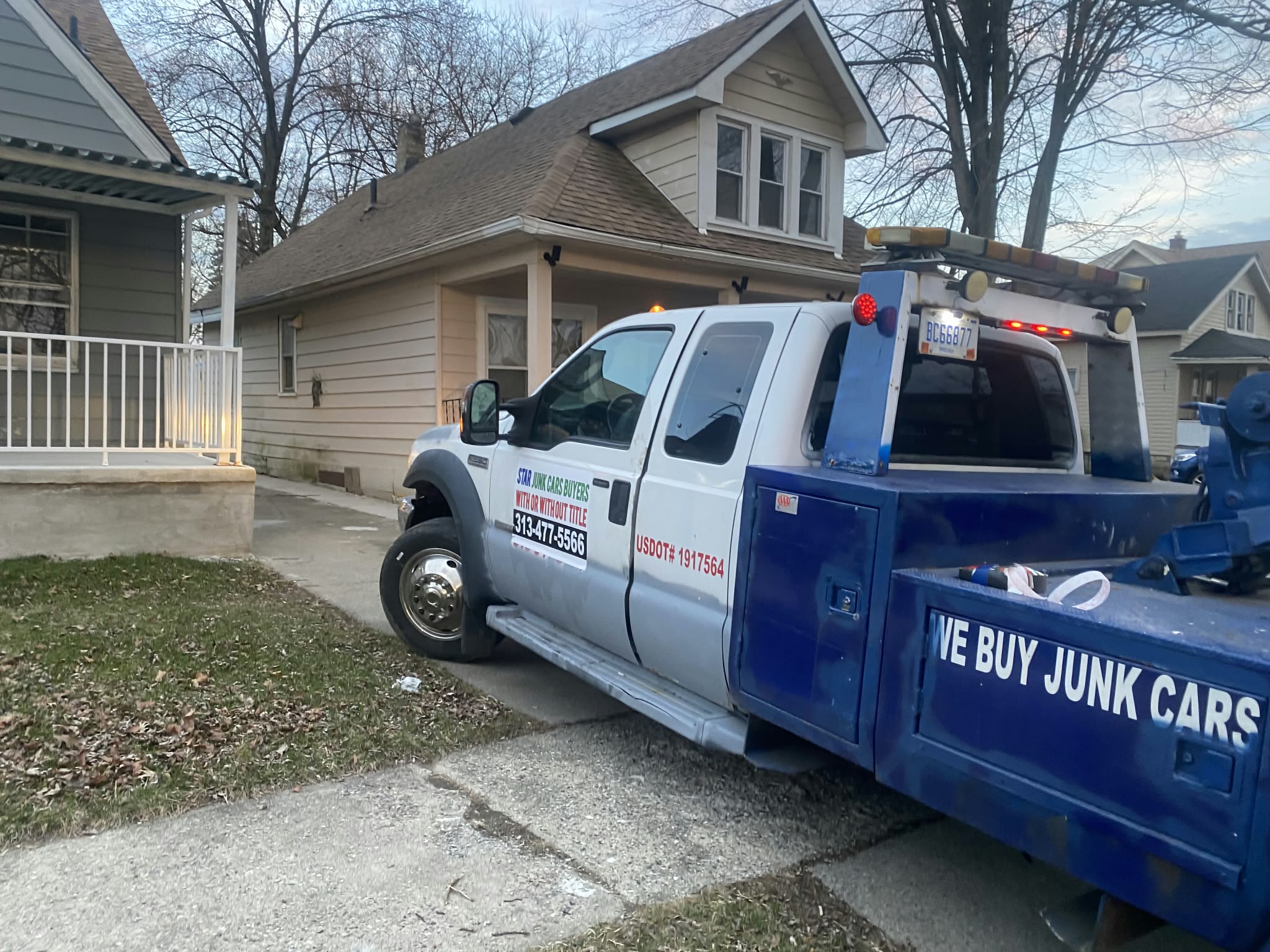 STAR Junk Cars tow truck at a residential pickup